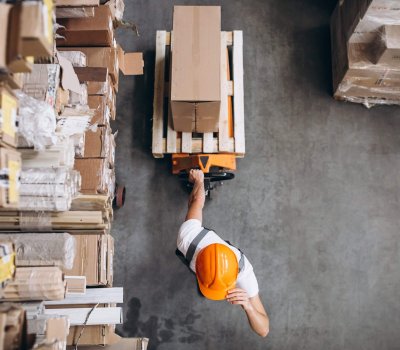 Young man working at a warehouse with boxes Young man working at a warehouse with boxes